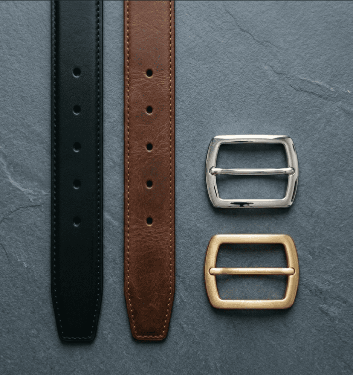 Men's interchangeable belt system with black and brown leather straps alongside silver and gold buckles