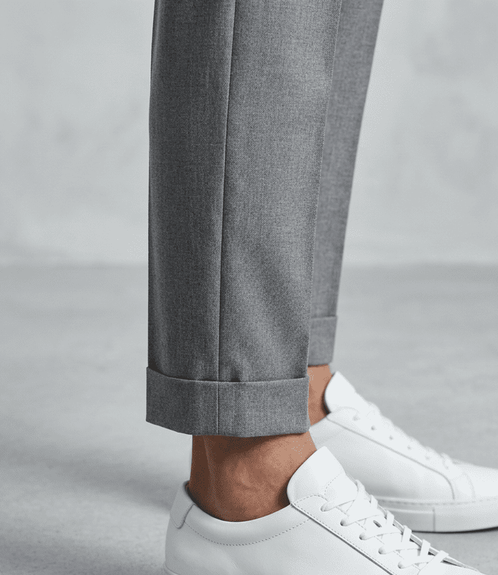 Outfit ideas for short men showing high-rise tapered trousers with no break at the ankle